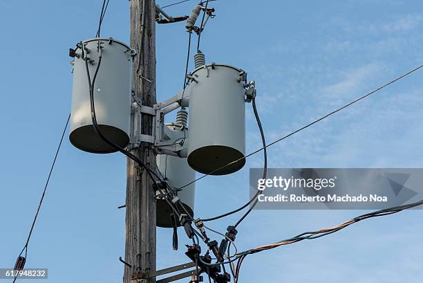 Urban hydro one pole with electrical transformers and wires connected.