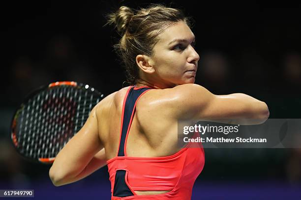 Simona Halep of Romania plays a forehand in her singles match against Angelique Kerber of Germany during day 3 of the BNP Paribas WTA Finals...