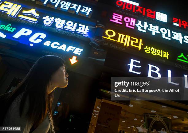 North korean teen defector in front of neon lights in the street, national capital area, seoul, South Korea on June 3, 2016 in Seoul, South Korea.