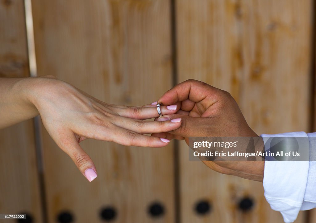 North korean defector joseph park putting wedding ring on the finger of his south korean fiancee juyeon, Sudogwon, Paju, South korea