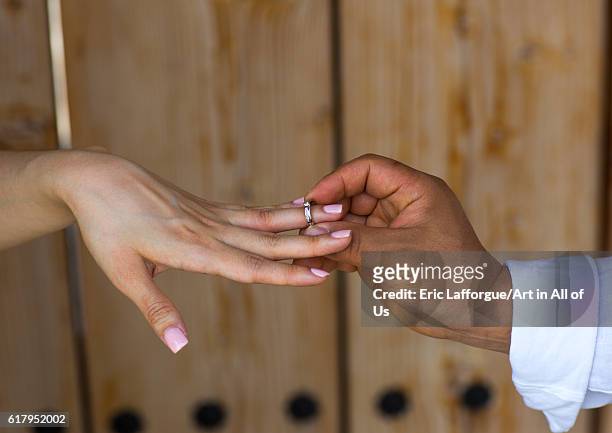 North korean defector joseph park putting wedding ring on the finger of his south korean fiancee juyeon, sudogwon, paju, South Korea on May 31, 2016...