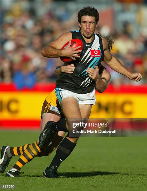 Roger James for Port is tackled by Shane Crawford for Hawthorn during the Round 10 Hawthorn Hawks versus the Port Adelaide Power AFL match, played at...