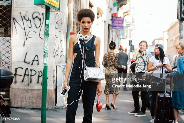 Dominican model Lineisy Montero wears black overalls over a blue sports bra white headphones, and silver Dior Diorama bag after the Dolce & Gabbana...