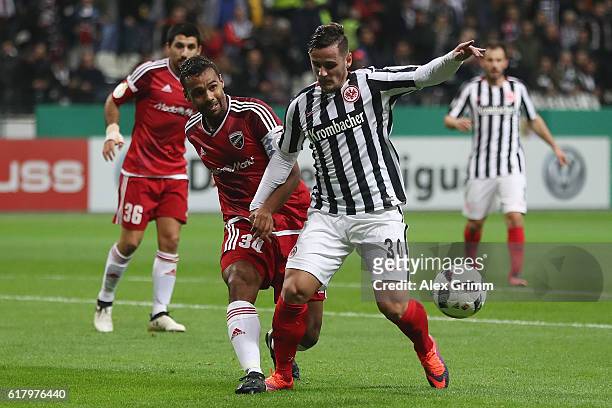 Shani Tarashaj of Frankfurt is challenged by Marvin Matip of Ingolstadt during the DFB Cup Second Round match between Eintracht Frankfurt and FC...