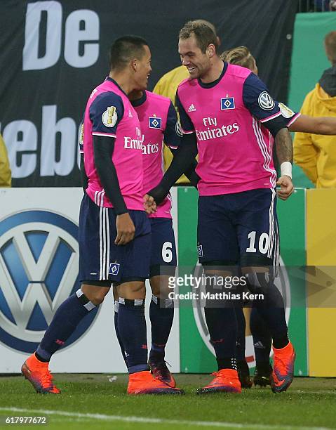 Pierre Michel Lasogga of Hamburg jubilates with team mate Bobby Wood after scoring the third goal during the DFB Cup second round match between...