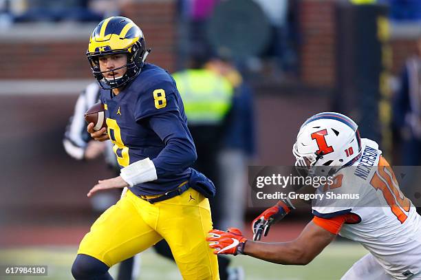 John O'Korn of the Michigan Wolverines looks for running room while playing the Illinois Fighting Illini on October 22, 2016 at Michigan Stadium in...