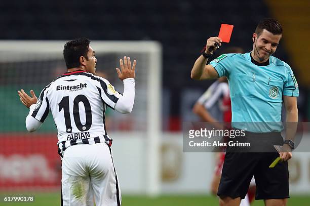 Marco Fabian of Frankfurt is sent off by referee Harm Osmers during the DFB Cup Second Round match between Eintracht Frankfurt and FC Ingolstadt at...