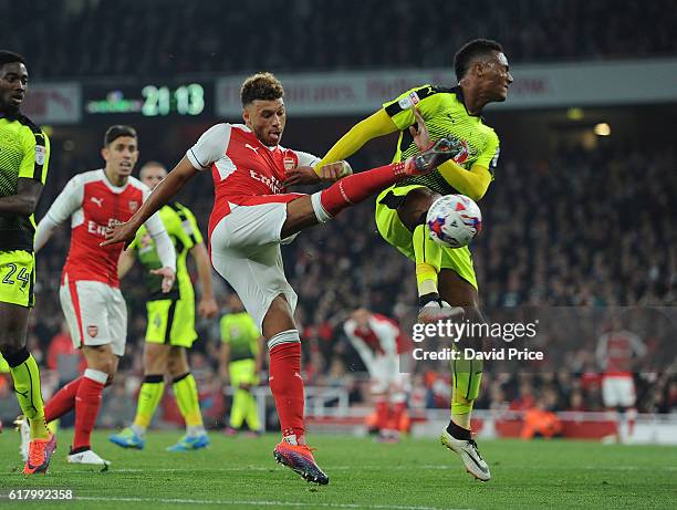 Alex Oxlade-Chamberlain of Arsenal volleys under pressure from Sandro Wieser of Reading during the match between Arsenal and Reading at Emirates...