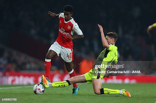 Gedion Zelalem of Arsenal is tackled by George Evans of Reading during the EFL Cup fourth round match between Arsenal and Reading at Emirates Stadium...