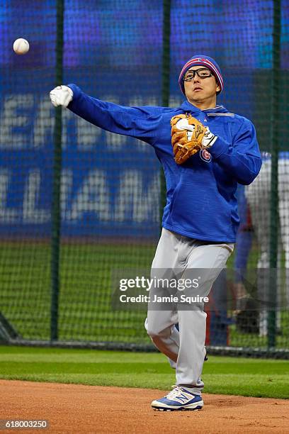 Munenori Kawasaki of the Chicago Cubs warms up prior to Game One of the 2016 World Series against the Cleveland Indians at Progressive Field on...