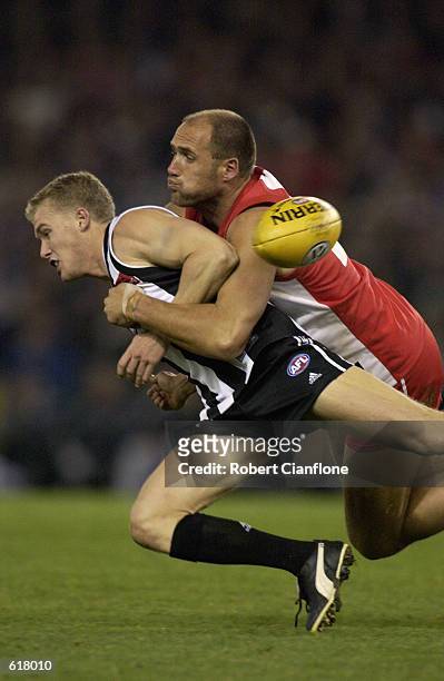 Tarkyn Lockyer of the Magpies is tackled by Tony Lockett of the Swans during the round 10 AFL match between the Collingwood Magpies and the Sydney...