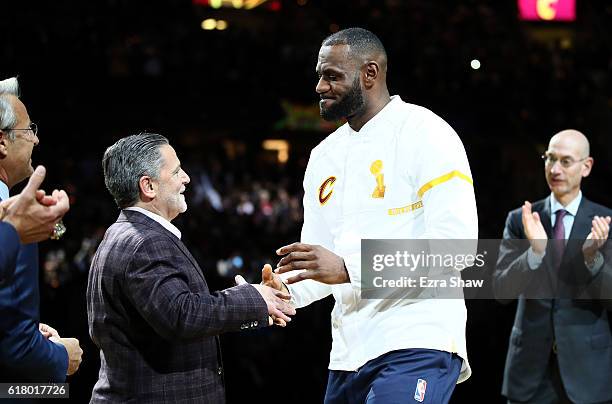 LeBron James of the Cleveland Cavaliers recieves his championship ring from owner Dan Gilbert before the game against the New York Knicks at Quicken...