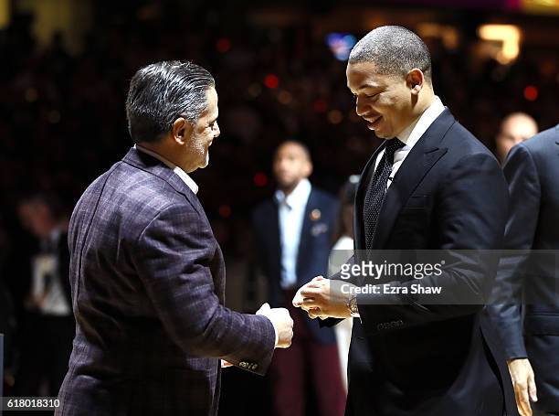 Tyronn Lue of the Cleveland Cavaliers receives his championship ring from owner Dan Gilbert before the game against the New York Knicks at Quicken...