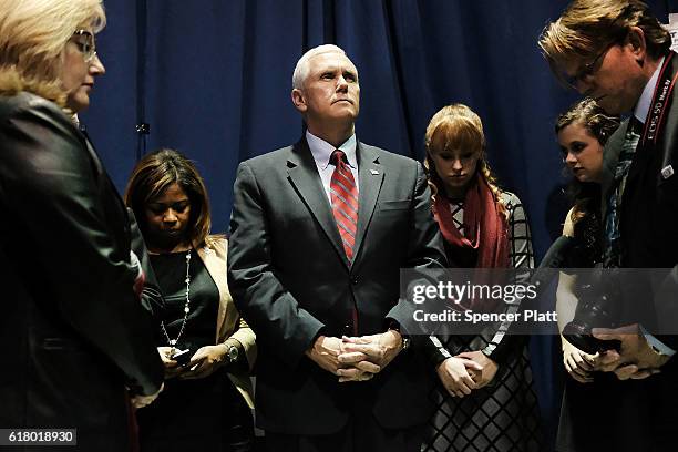 Republican Vice Presidential Candidate Mike Pence prays with his staff before taking the stage on October 25, 2016 in Marietta, Ohio. Ohio has become...