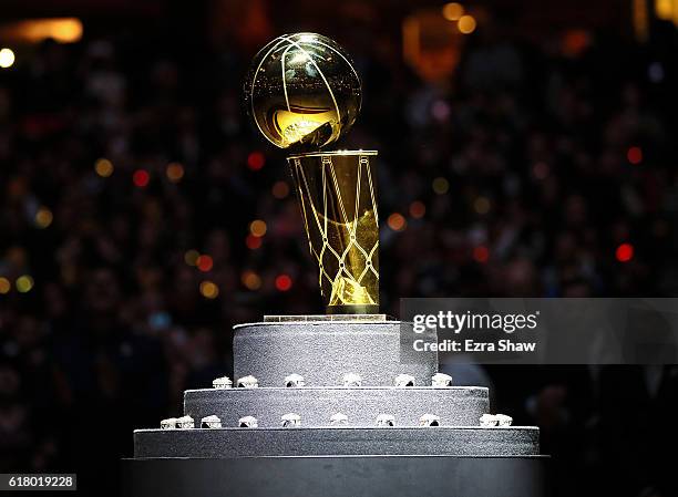 The Larry O'Brien championship trophy sits with the Cleveland Cavaliers rings before the game against the New York Knicks at Quicken Loans Arena on...