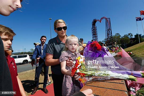 Local resident Nicole Baker and her daughter Charlize lay flowers at Dreamworld on October 26, 2016 in Gold Coast, Australia. Four people were killed...