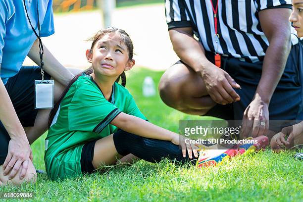 young soccer player cries after injuring ankle - soccer injury stock pictures, royalty-free photos & images