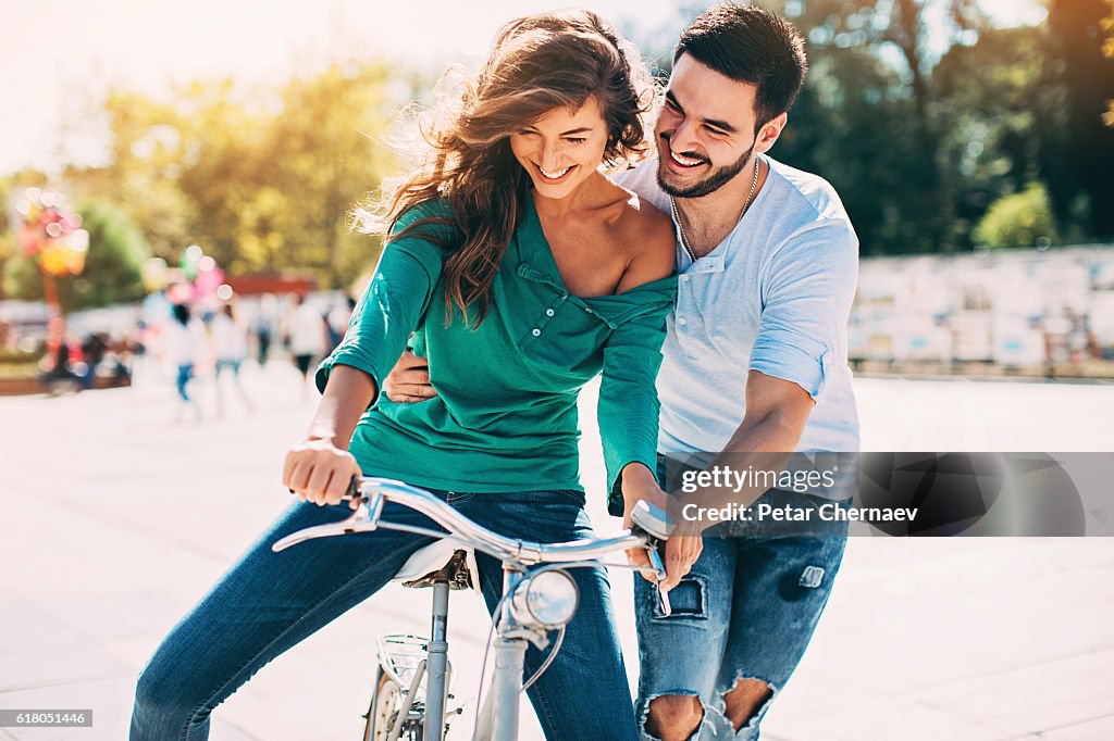 Gf Ride Artist Young Man Helping His Girlfriend To Ride A Bike High-Res Stock Photo ...