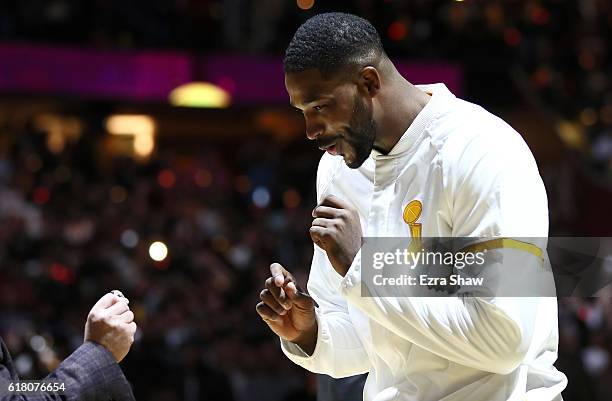 Tristan Thompson of the Cleveland Cavaliers receives his championship ring from owner Dan Gilbert before the game against the New York Knicks at...