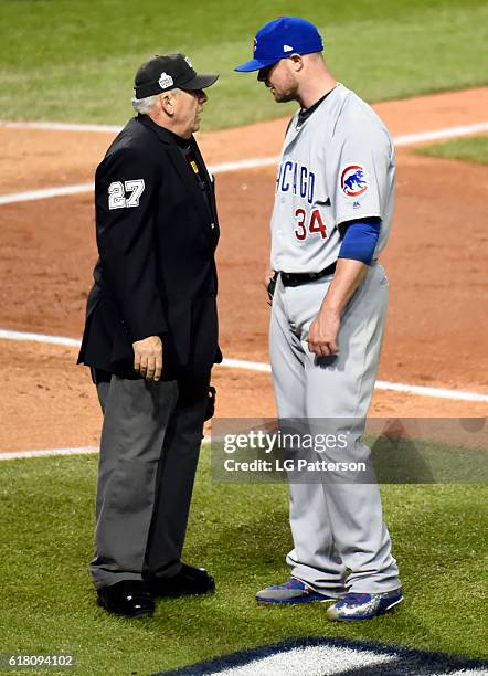 Jon Lester of the Chicago Cubs talks with home plate umpire Larry Vanover after the third inning during Game 1 of the 2016 World Series against the...