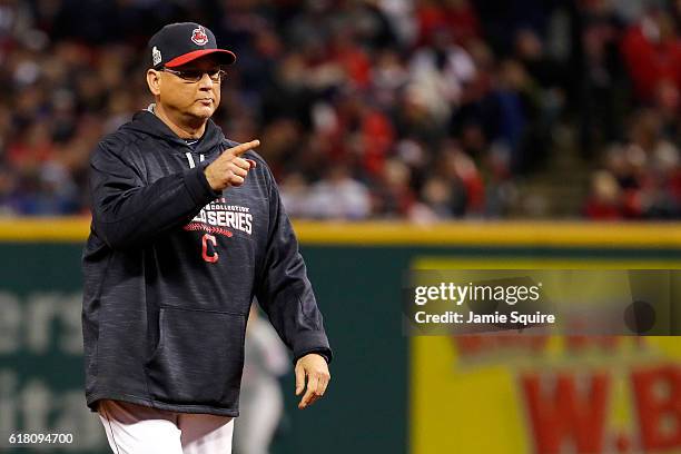 Manager Terry Francona of the Cleveland Indians walks on the field after Carlos Santana , suffered an apparent injury during the third inning in Game...