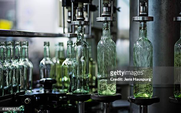 wine bottles in bottling plant - filling stock pictures, royalty-free photos & images