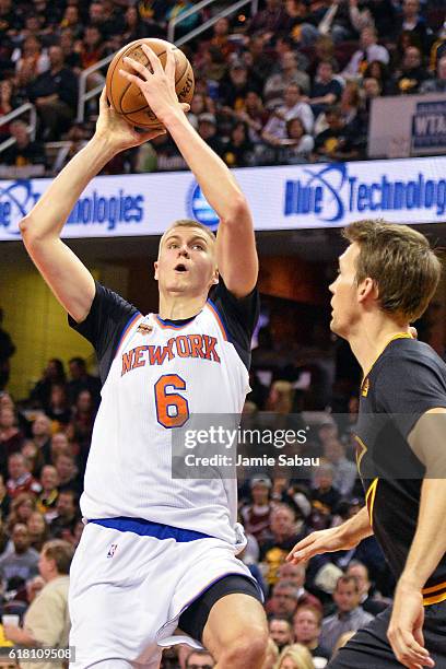 Kristaps Porzingis of the New York Knicks shoots over Mike Dunleavy of the Cleveland Cavaliers in the first half on October 25, 2016 at Quicken Loans...