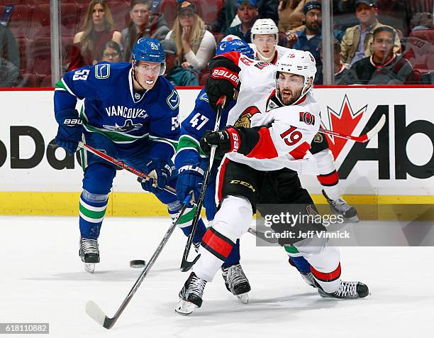 Bo Horvat of the Vancouver Canucks watches Derick Brassard of the Ottawa Senators play the puck during their NHL game at Rogers Arena October 25,...