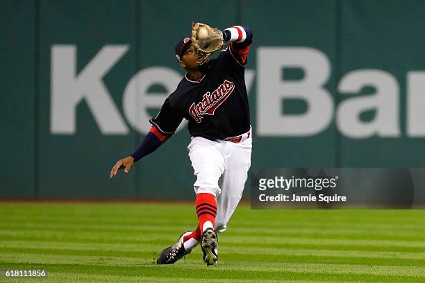 Rajai Davis of the Cleveland Indians catches a fly ball hit by Anthony Rizzo of the Chicago Cubs during the eighth inning in Game One of the 2016...