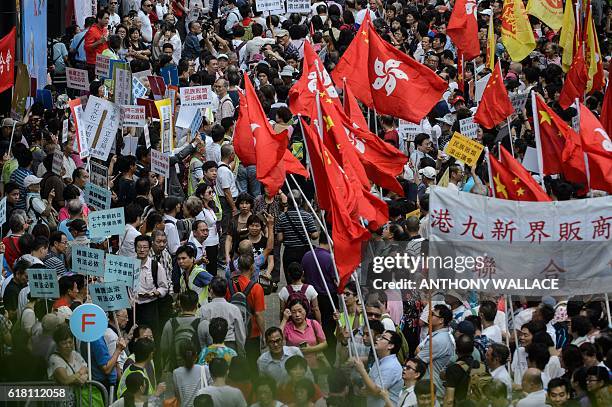 Pro-Beijing supporters gather outside the Legislative Council in Hong Kong on October 26, 2016. Thousands of pro-government supporters protested...