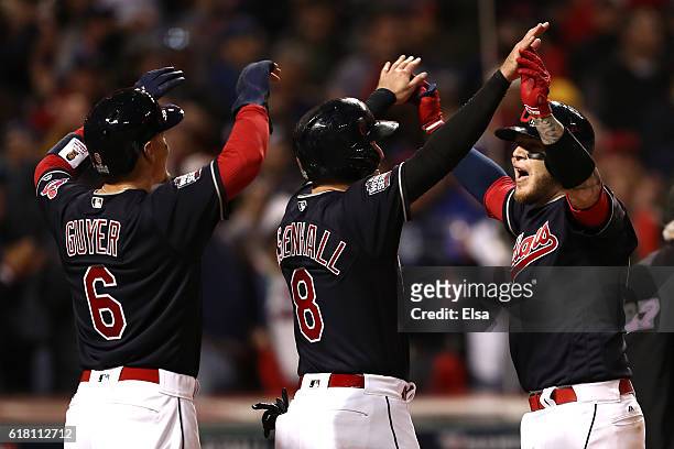 Roberto Perez of the Cleveland Indians celebrates with Lonnie Chisenhall and Brandon Guyer after hitting a three-run home run during the eighth...