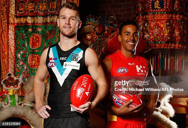 Robbie Gray of the Power and Touk Miller of the Suns pose for a photograph during an AFL announcement at The Chinese Museum Melbourne on October 26,...