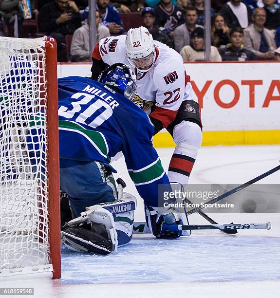 Vancouver Canucks Goalie Ryan Miller makes a save on Ottawa Senators Center Chris Kelly during a game at Rogers Arena in Vancouver BC.