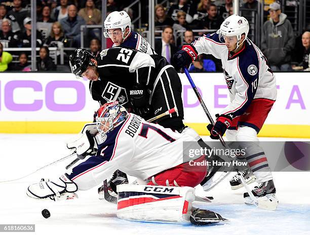 Sergei Bobrovsky of the Columbus Blue Jackets smothers the puck in front of Dustin Brown of the Los Angeles Kings during the second period at Staples...