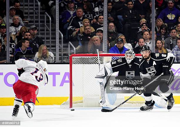 Cam Atkinson of the Columbus Blue Jackets scores on a powerplay past Peter Budaj and Drew Doughty of the Los Angeles Kings to take a 2-1 lead during...