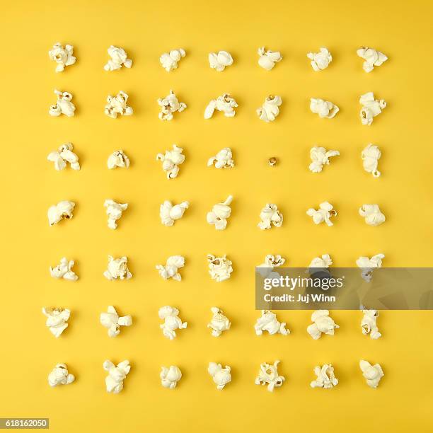 popcorn in a grid on yellow - popcorn stock pictures, royalty-free photos & images