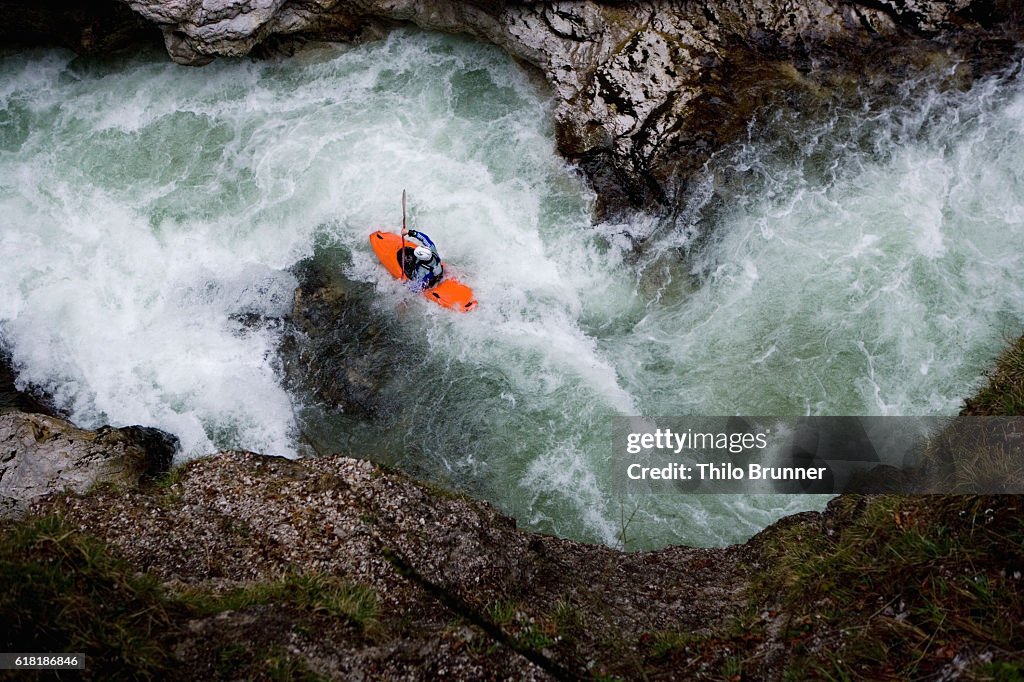 Kayaker going down river