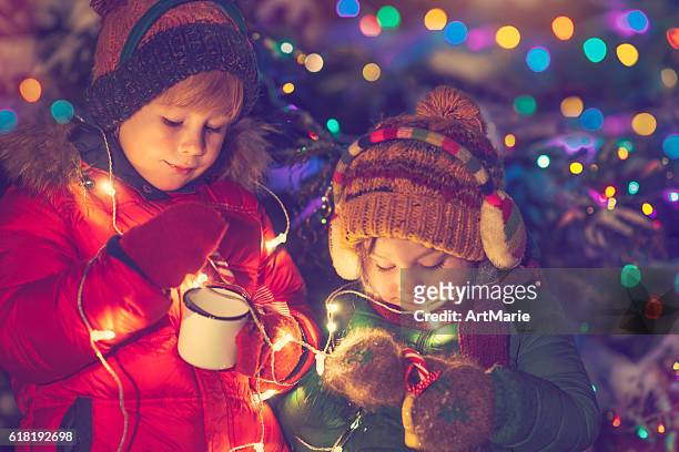 children in xmas - xmas tree snow lights silly stock pictures, royalty-free photos & images
