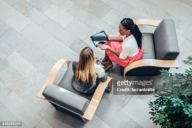 overhead view of women working together - above stock pictures, royalty-free photos & images