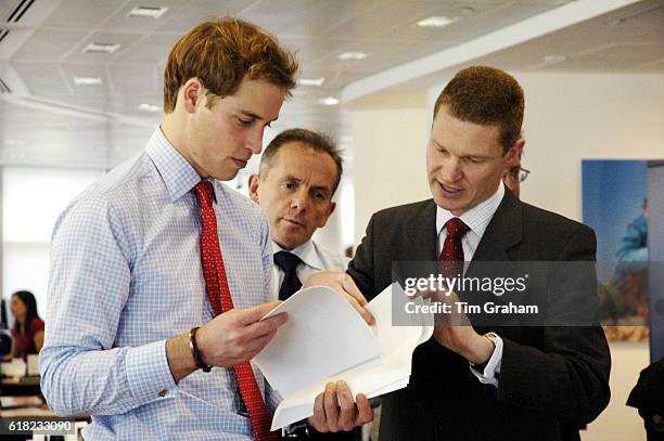 Prince William, Hiscox Plc MD Steve Langan and James Standen of Aon look at fine art risks at a specialist insurance company office. Prince William...