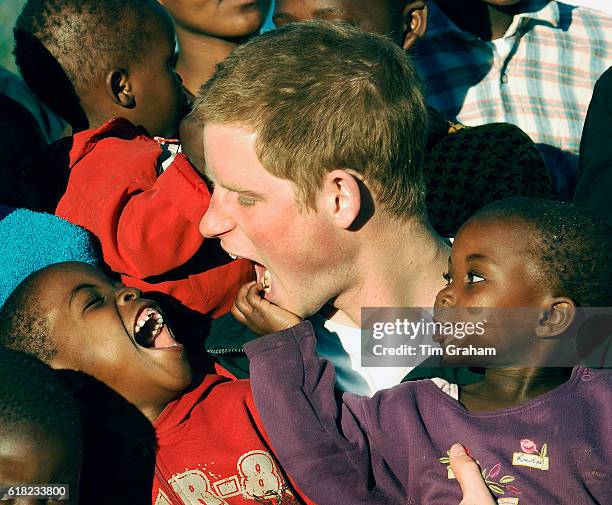 Prince Harry cuddles children Mutsu and Lintle , in the grounds of the Mants'ase children's home, while on a return visit to Lesotho in southern...