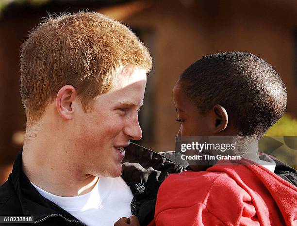 Prince Harry holds his friend, Mutsu Potsane, in the grounds of the Mants'ase children's home, while on a return visit to Lesotho in southern Africa....