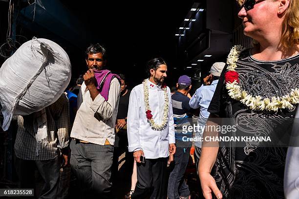 Chef to the Prime Minister of Canada, Niel Dhawan , walks with other chefs to various heads of state as they visit the spice market in the old...