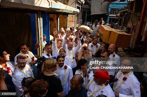 The chefs to various heads of state pose for a photograph as they visit the spice market in the old quarters of New Delhi on October 25, 2016. The...