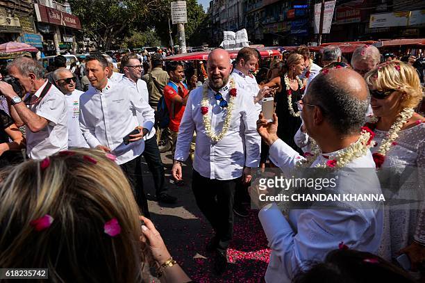 Chef to the King of Sweden, Magnus Ake Rehback, looks on as he walks with other chefs to various heads of state as they visit the spice market in the...