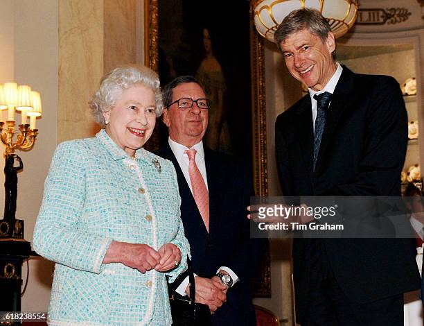 Queen Elizabeth II meets Arsenal chairman Peter Hill-Wood and manager Arsene Wenger at Buckingham Palace