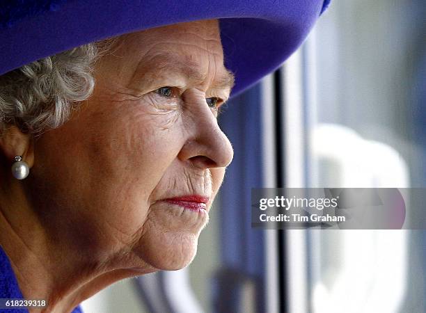 Queen Elizabeth II looks out from a window at the underwater stage at Pinewood Studios | Location: Iver Heath, England, United Kingdom.