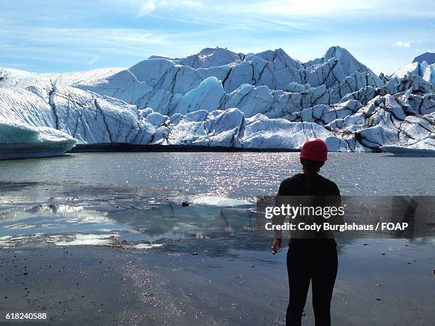 rear view of person standing against glacier - anchorage foto e immagini stock