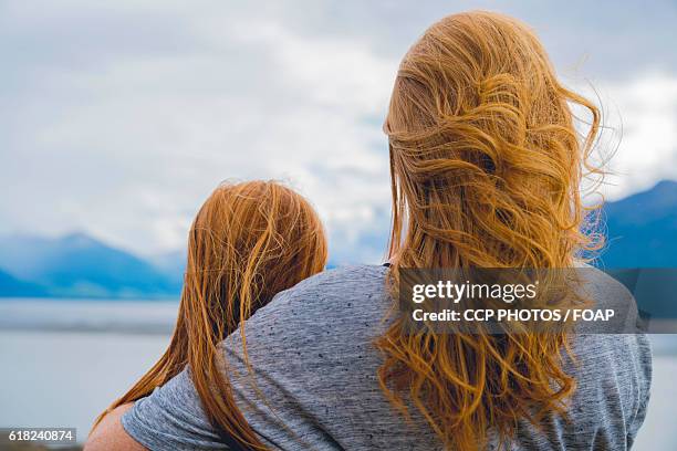 mother & daughter looking at lake - anchorage foto e immagini stock