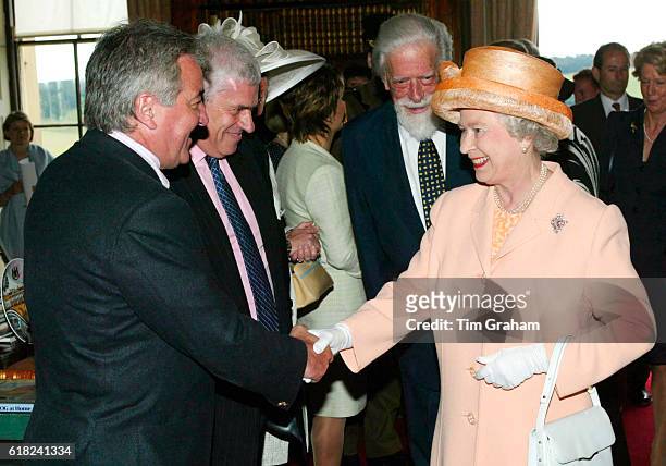 Queen Elizabeth II happy and smiling as she meets newly appointed Leeds United football manager Terry Venables during her visit to Harewood House,...
